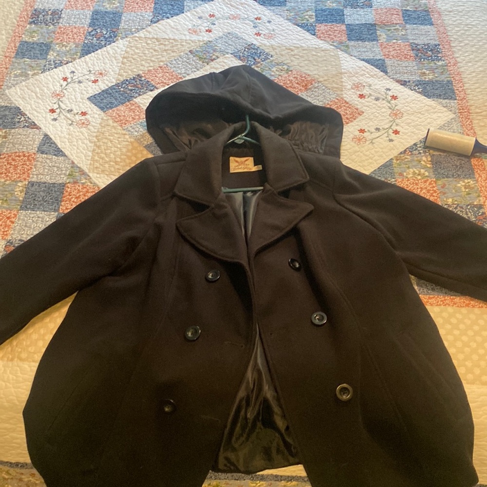 Double breasted winter coat with button on hood.